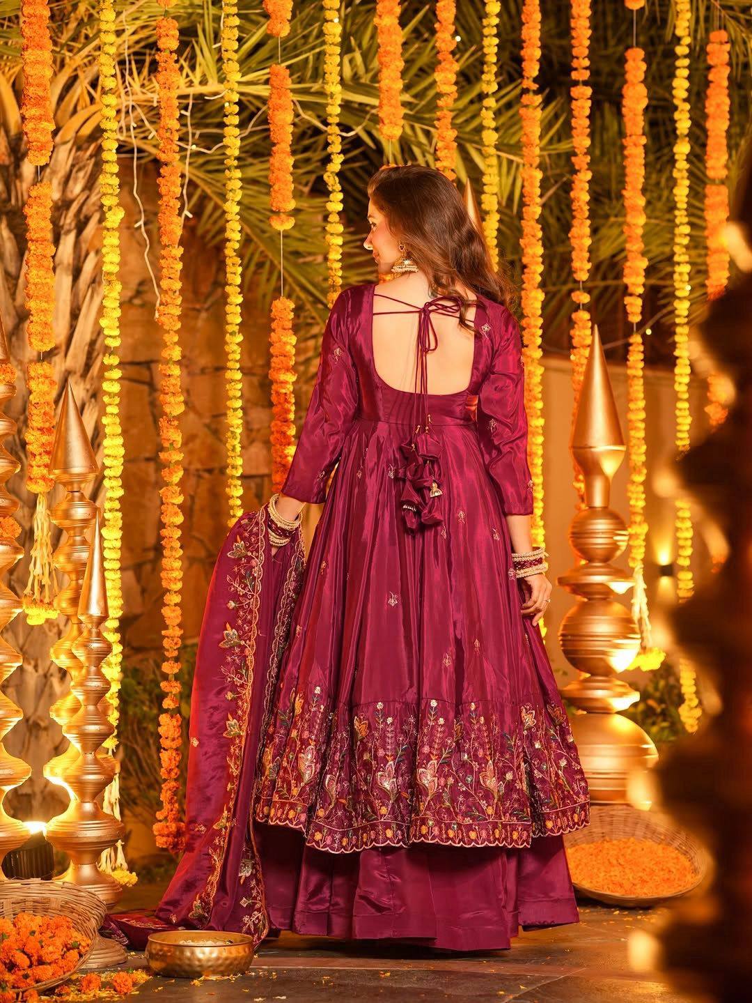Woman wearing festive wedding Anarkali suit with heavy dupatta and traditional jewelry