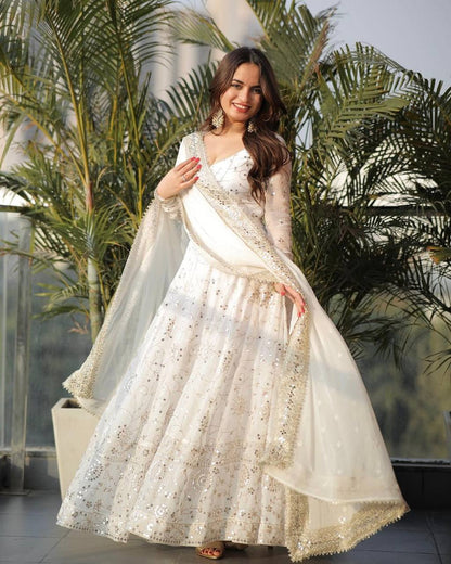 Close-up of embroidery sequence work on white Anarkali gown