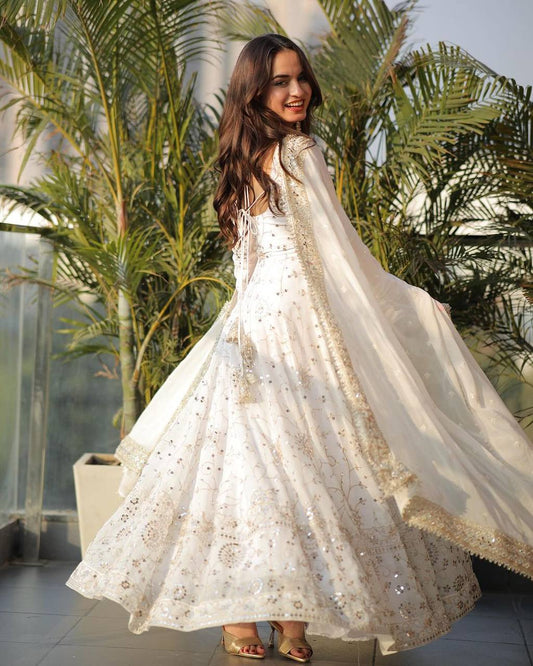 Back view of elegant white Anarkali gown with full sleeves and flare